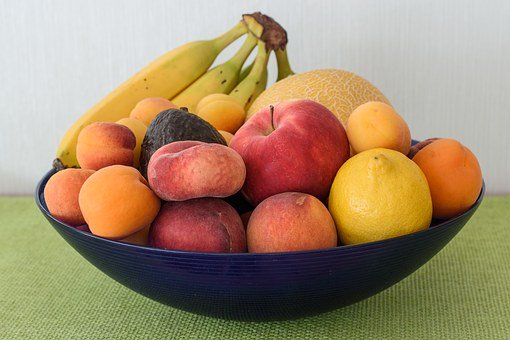 A fruit bowl on a green table