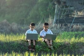 Two Boys Holding Laptops